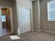 Bedroom with carpet, natural light from window, and closet with sliding doors at 8945 Rifle St, Commerce City, CO 80022