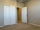 Bedroom with carpet flooring, double closet doors and open door to another room at 8945 Rifle St, Commerce City, CO 80022