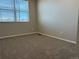 Inviting bedroom featuring neutral carpet, a large window, and ample natural light at 8945 Rifle St, Commerce City, CO 80022