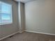 Cozy bedroom featuring neutral carpet, a window with blinds, and a plug at 8945 Rifle St, Commerce City, CO 80022