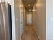 Inviting hallway with light wood floors, neutral paint, and a white front door at 8945 Rifle St, Commerce City, CO 80022