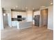 Bright kitchen featuring stainless steel appliances, center island, white cabinets, and an open layout at 8945 Rifle St, Commerce City, CO 80022