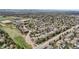 A sweeping aerial view of an established neighborhood with mature trees and curved roadways at 5459 E Dry Creek Cir, Centennial, CO 80122