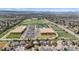 A high angle aerial of homes and nearby commercial areas and fields at 5459 E Dry Creek Cir, Centennial, CO 80122