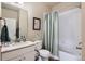 Neutral toned bathroom featuring a shower-tub combo and single sink vanity at 2225 Santini Trl # A, Littleton, CO 80129