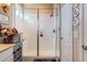 Modern bathroom with a glass-enclosed shower, white tile, and stylish fixtures at 2225 Santini Trl # A, Littleton, CO 80129