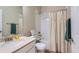 Well-lit bathroom with a shower-tub combination, vanity and modern fixtures at 2225 Santini Trl # A, Littleton, CO 80129