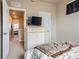 Cozy bedroom showcasing a television on dresser and plush bedding creating a relaxing private space at 2225 Santini Trl # A, Littleton, CO 80129