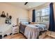 Cozy bedroom with neutral tones, a large window, and wood-look flooring at 2225 Santini Trl # A, Littleton, CO 80129