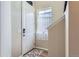 Bright entryway featuring a white front door, and a sunlit window providing natural light at 2225 Santini Trl # A, Littleton, CO 80129