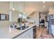 Bright kitchen featuring stainless steel appliances, a breakfast bar, and hardwood floors at 2225 Santini Trl # A, Littleton, CO 80129
