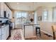 Bright kitchen with an island, white cabinets, and stainless steel appliances at 2225 Santini Trl # A, Littleton, CO 80129