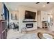 Bright living room featuring an electric fireplace, large TV, and modern decor at 2225 Santini Trl # A, Littleton, CO 80129
