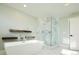 Bathroom with a freestanding tub and glass shower at 3050 S Ash St, Denver, CO 80222