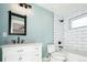 Bathroom with white subway tile, vanity, and bathtub at 3050 S Ash St, Denver, CO 80222