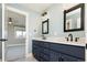 Double vanity bathroom with blue cabinets and mirrors at 3050 S Ash St, Denver, CO 80222