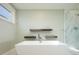 Elegant bathroom with soaking tub, walk-in shower, and floating shelves at 3050 S Ash St, Denver, CO 80222