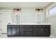 Double vanity bathroom with dark cabinetry and quartz countertops at 3050 S Ash St, Denver, CO 80222