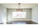 Bright dining room with hardwood floors and a modern light fixture at 3050 S Ash St, Denver, CO 80222