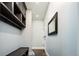 Bright entryway with built-in bench, shelving, and mirror at 3050 S Ash St, Denver, CO 80222