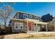 Two-story craftsman style home with gray siding, stone accents and a red door at 3050 S Ash St, Denver, CO 80222