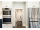 View down hallway with dark hardwood floors and access to other rooms at 3050 S Ash St, Denver, CO 80222