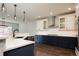 Modern kitchen with white and navy cabinets, quartz countertops and stainless steel appliances at 3050 S Ash St, Denver, CO 80222