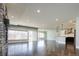 Open concept living space with hardwood floors, stone fireplace and kitchen island at 3050 S Ash St, Denver, CO 80222