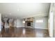 Spacious living room with hardwood floors, stone fireplace, and large windows at 3050 S Ash St, Denver, CO 80222