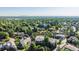 Overhead shot of a lush neighborhood with city views on the horizon at 2587 S Harlan Ct, Lakewood, CO 80227
