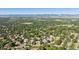 Elevated view featuring the residential neighborhood with mature trees and distant mountains at 2587 S Harlan Ct, Lakewood, CO 80227