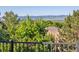 Wooded backyard featuring fence, greenery, and mountain views at 2587 S Harlan Ct, Lakewood, CO 80227