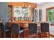 Close up view of basement bar featuring wood detailing, decorative mirror, and wine rack at 2587 S Harlan Ct, Lakewood, CO 80227