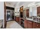 Luxurious bathroom with double sinks, marble countertops, a walk-in shower, and access to the closet at 2587 S Harlan Ct, Lakewood, CO 80227