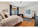 Inviting bedroom with hardwood floors and a view of the trees outside the window at 2587 S Harlan Ct, Lakewood, CO 80227