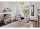 Charming bedroom with a canopy bed, hardwood floors, desk area, and bright window view at 2587 S Harlan Ct, Lakewood, CO 80227