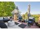 Outdoor deck area showcasing stylish seating with umbrellas and views of a wooded landscape at 2587 S Harlan Ct, Lakewood, CO 80227