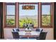 Bright dining area with picturesque mountain views, a decorative chandelier, and seating for four at 2587 S Harlan Ct, Lakewood, CO 80227