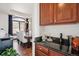Wet bar with granite counters next to a dining room with a large window and modern chandelier at 2587 S Harlan Ct, Lakewood, CO 80227