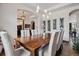 Dining room with hardwood floors, pendant lighting, a long dining table, and elegant white chairs at 2587 S Harlan Ct, Lakewood, CO 80227