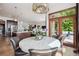 Dining room with a decorative chandelier, a round table with chairs, access to the kitchen, and view to the living room at 2587 S Harlan Ct, Lakewood, CO 80227