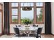 Dining room with large windows offering scenic views, a decorative chandelier, and a round table with chairs at 2587 S Harlan Ct, Lakewood, CO 80227