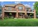 Back of property with brick elevation and multiple decks overlooking a grassy backyard at 2587 S Harlan Ct, Lakewood, CO 80227