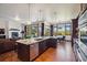Open floor plan kitchen featuring an island with a granite countertop, stainless steel appliances, and exterior view at 2587 S Harlan Ct, Lakewood, CO 80227