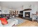 Cozy living room features a modern fireplace, hardwood floors, comfortable seating, and a view to the entryway at 2587 S Harlan Ct, Lakewood, CO 80227