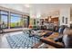 Expansive living room features a large leather sectional and a view of the exterior landscape at 2587 S Harlan Ct, Lakewood, CO 80227