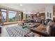 Bright living room featuring large windows with a scenic view, a leather sofa, and an open layout at 2587 S Harlan Ct, Lakewood, CO 80227