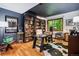 Office space featuring custom bookshelves, desk, and a view of mature trees at 2587 S Harlan Ct, Lakewood, CO 80227