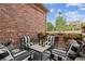 Outdoor patio featuring brick walls, comfortable seating, and decorative flower boxes for relaxing and entertaining at 2587 S Harlan Ct, Lakewood, CO 80227