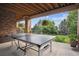 Outdoor patio featuring a ping pong table overlooking the lawn and landscaping at 2587 S Harlan Ct, Lakewood, CO 80227